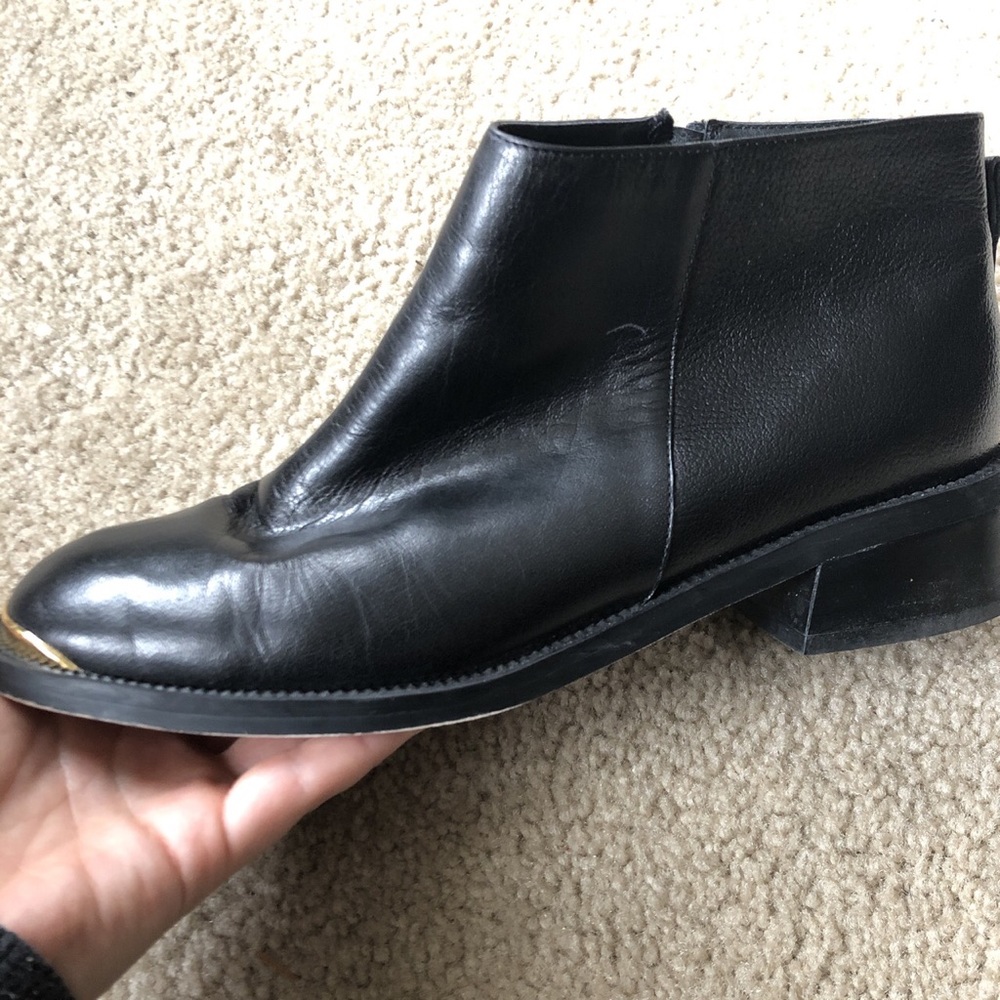 Gold tipped black leather boots
